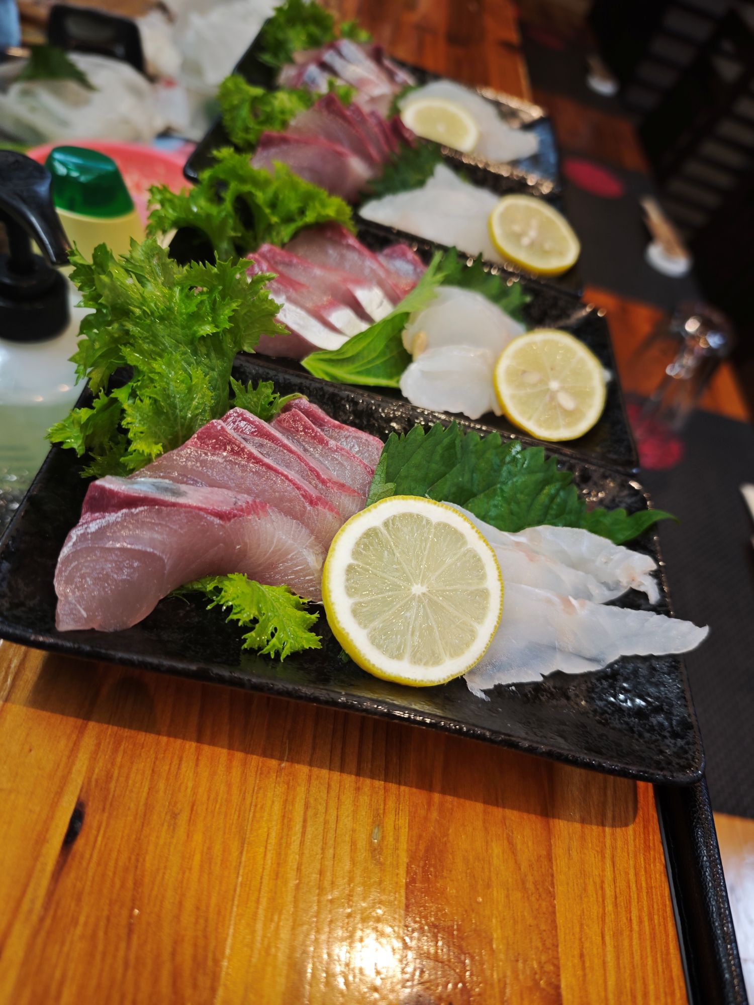 居酒屋 和の新鮮な刺身盛り合わせ、ブリ、マグロ、イカの豪華な一皿